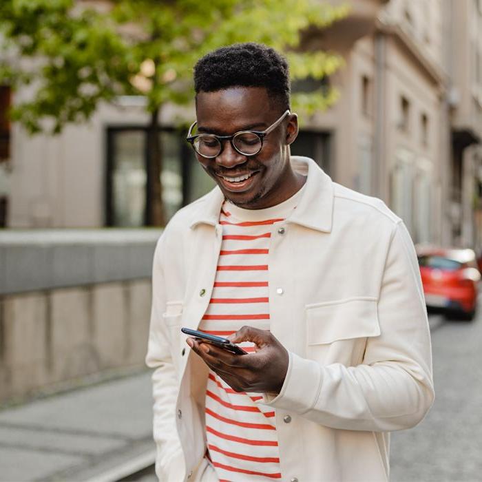 A Millennial uses Patelco Online on his phone to keep track of his bank accounts.